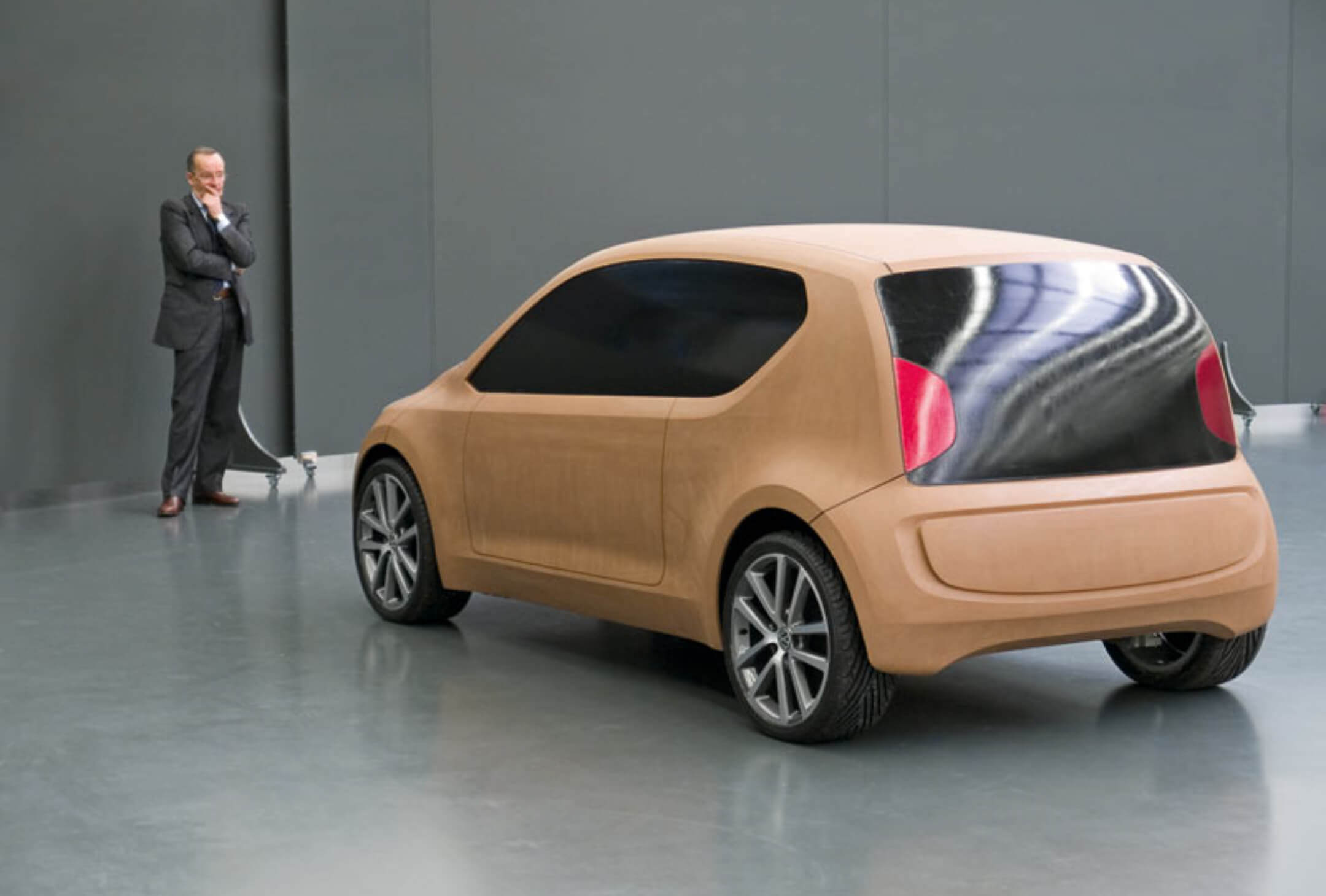 Volkswagen Group chief designer Walter de'Silva inspecting the clay model of the UP! concept, a critical step in refining the design and ensuring it aligns with the brand's vision and design principles. Volkswagen Group chief designer Walter de'Silva inspecting the clay model of the UP! concept, a critical step in refining the design and ensuring it aligns with the brand's vision and design principles.